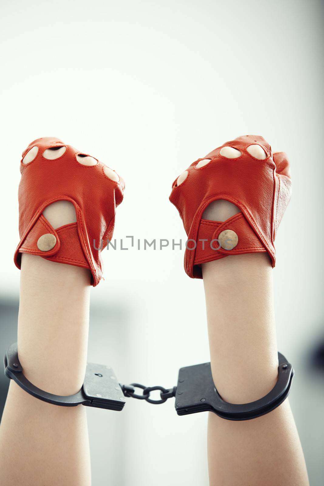 Two human hands in wristlets. Vertical photo