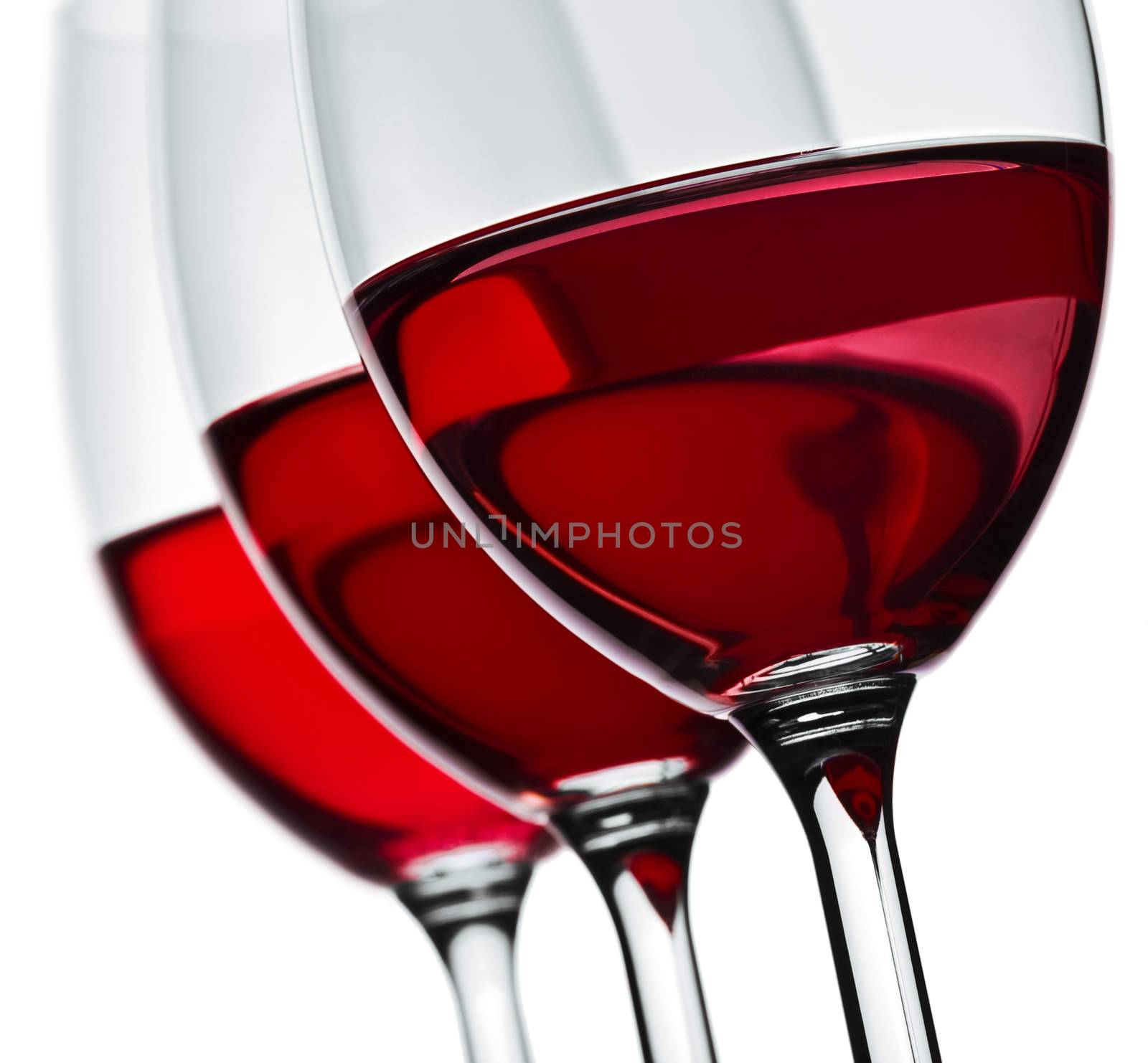 section of three wineglas with red wine isolated