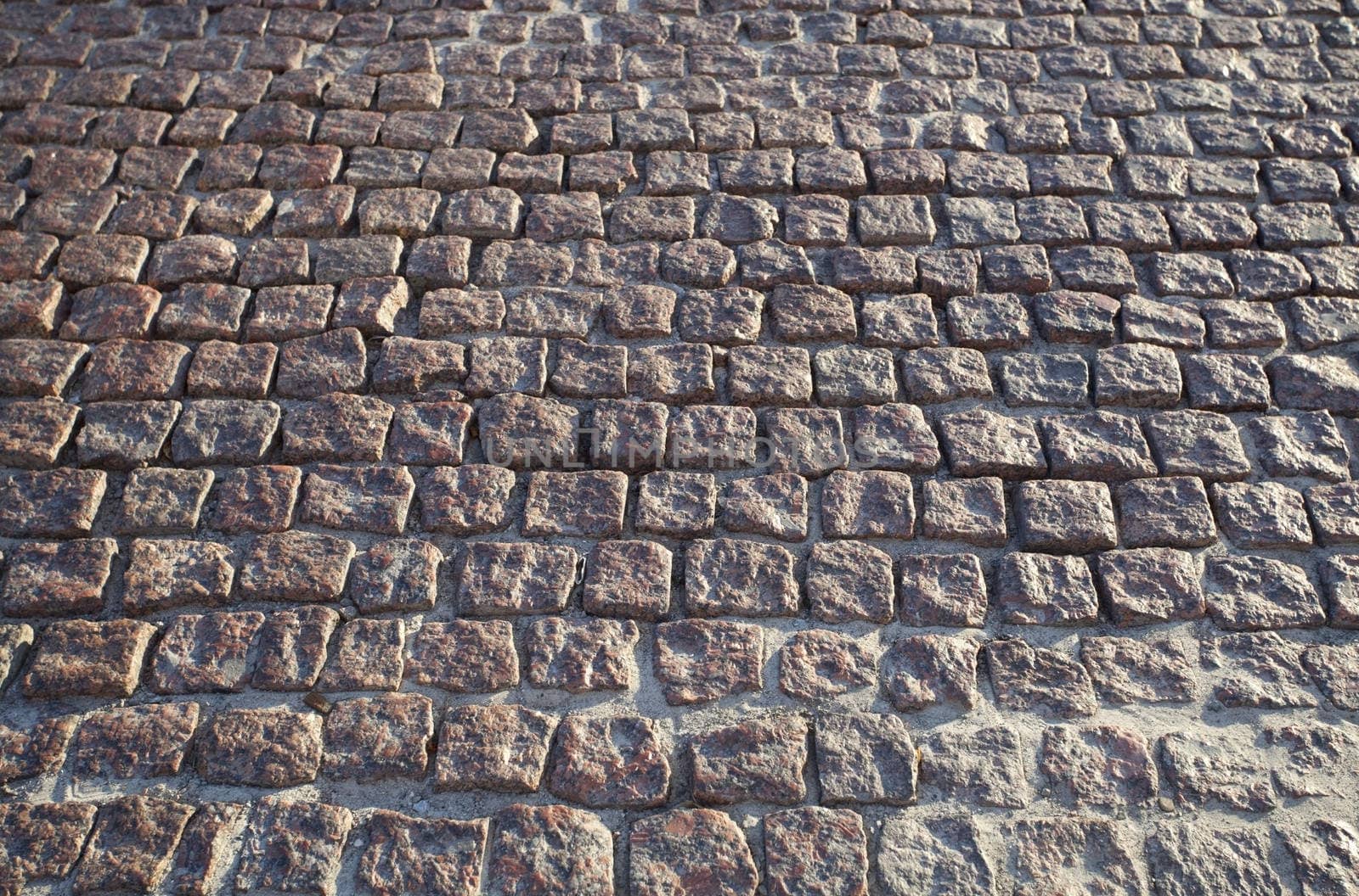 Granite cobblestoned pavement background.