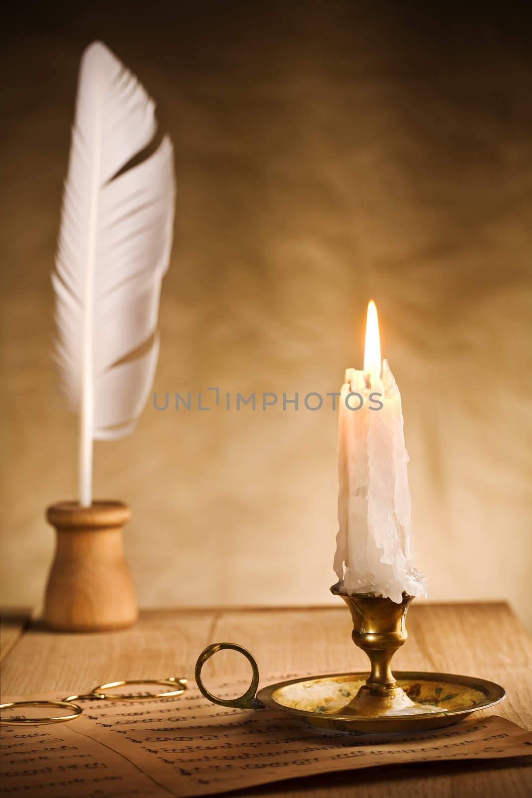 Romantic still-life with burning candle and music sheet