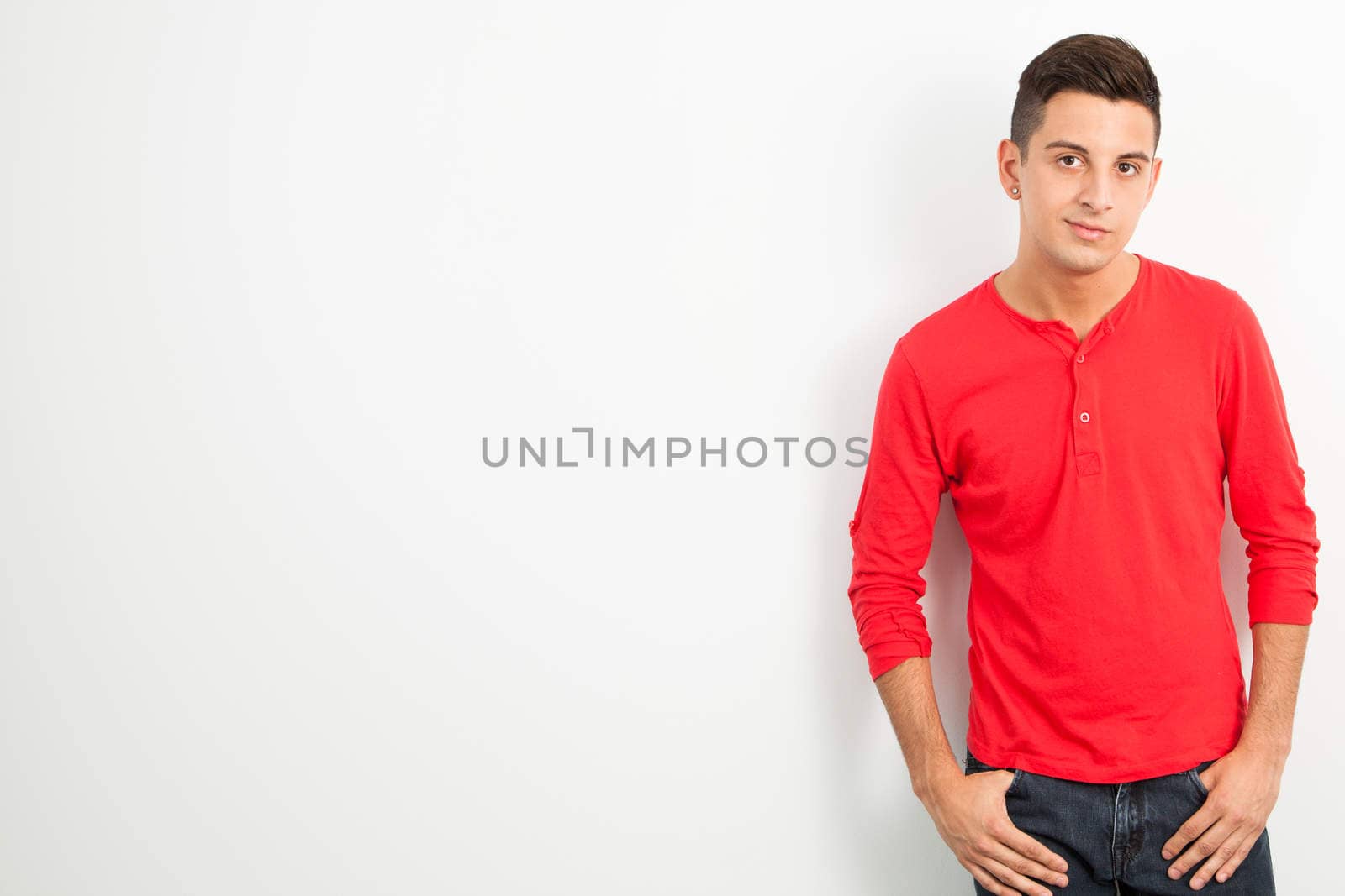 Young man posing against a white background by Izaphoto