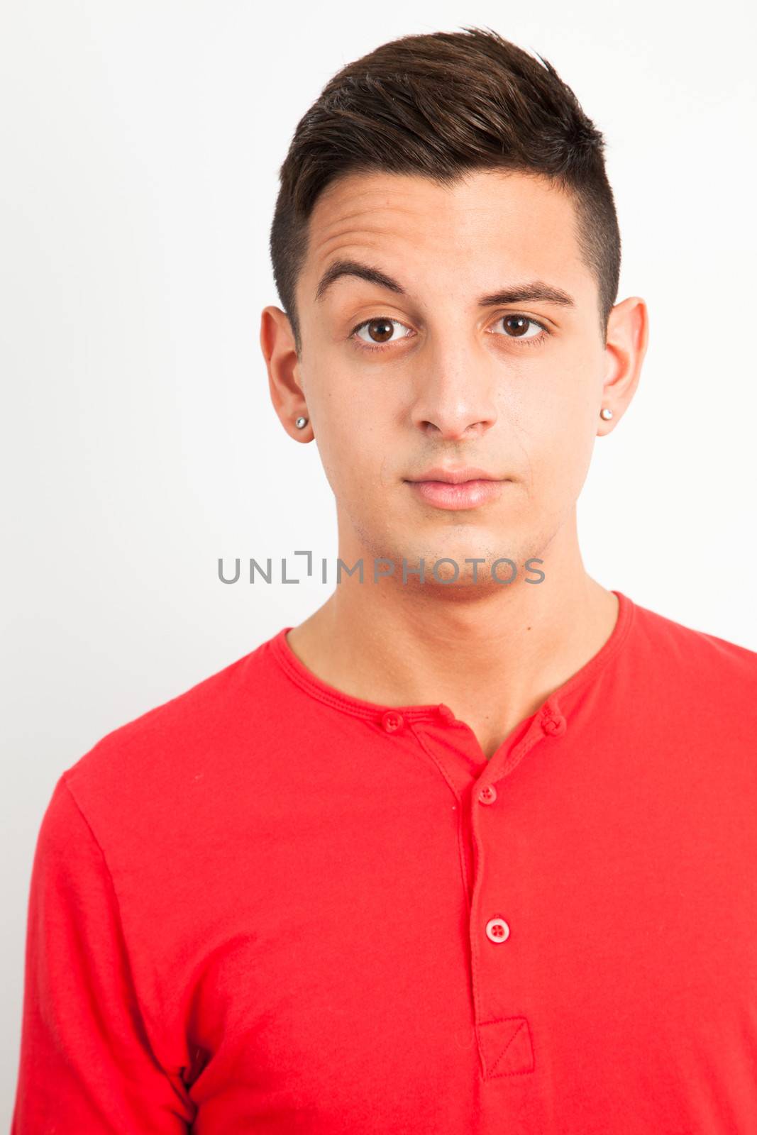 Young and handsome guy posing over white background