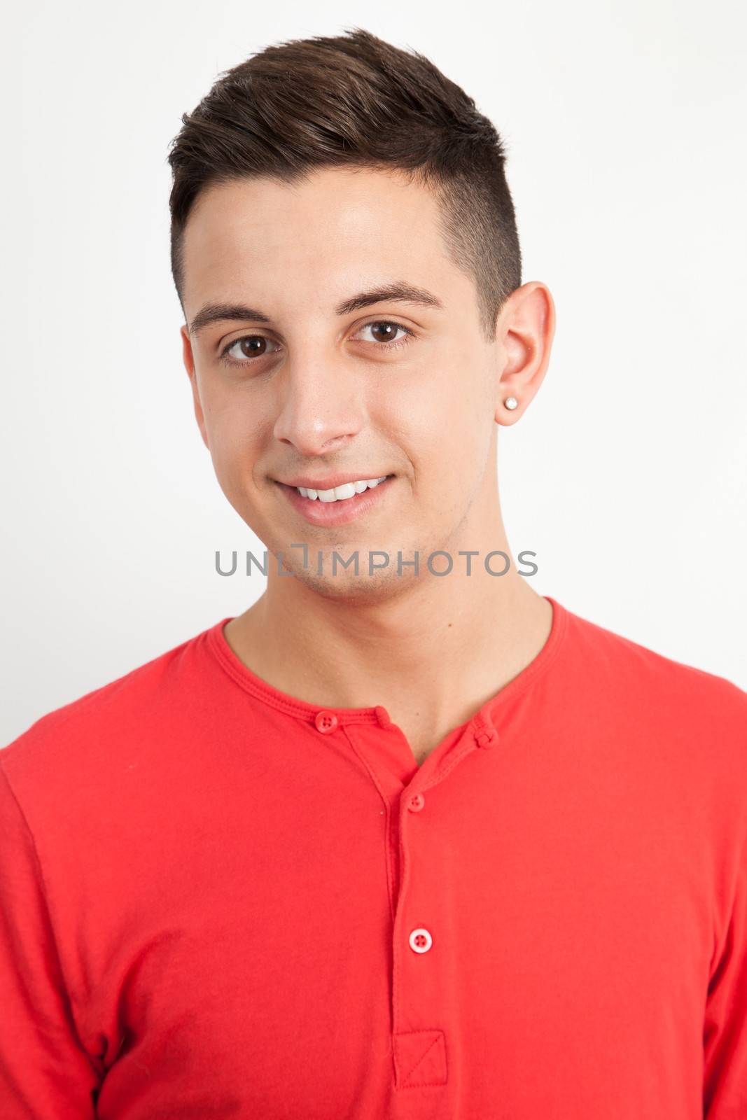 Young and handsome guy posing over white background