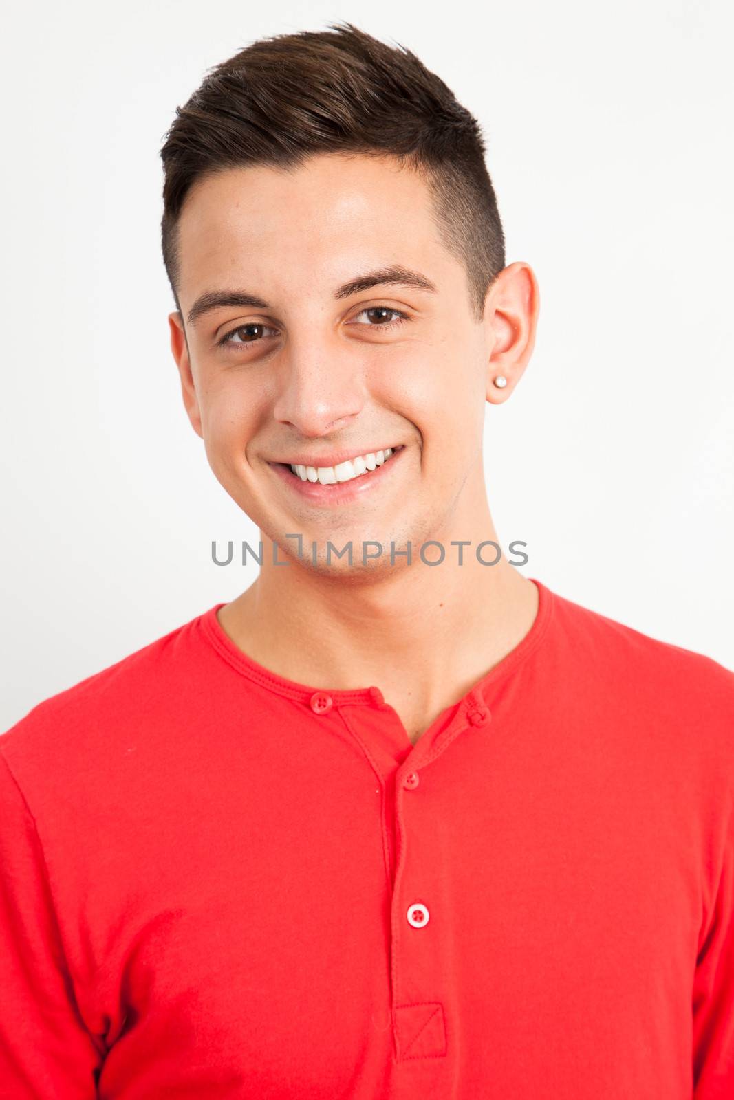 Young and handsome guy posing over white background