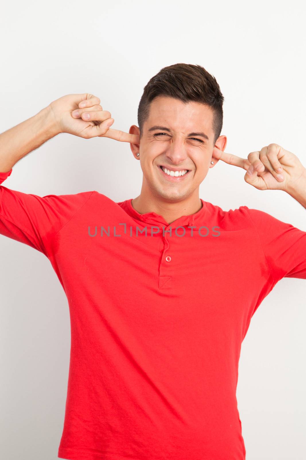 Young and handsome guy posing over white background