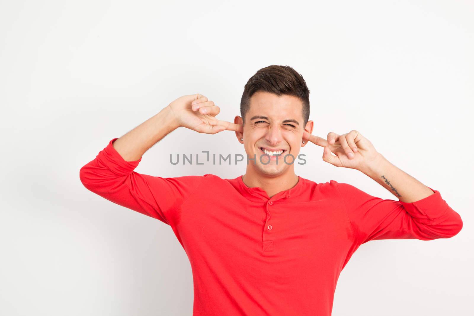 Young and handsome guy posing over white background