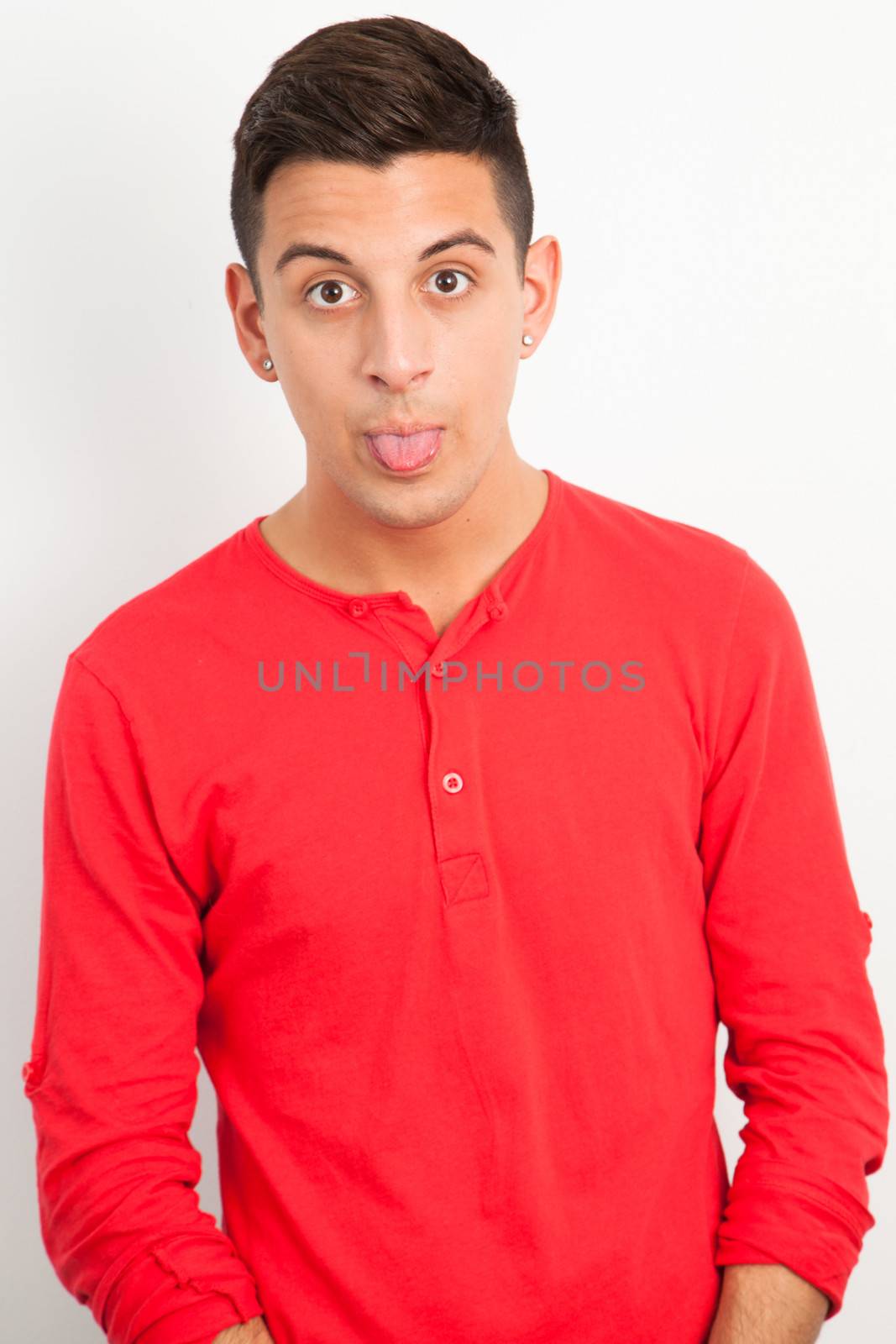 Young and handsome guy posing over white background