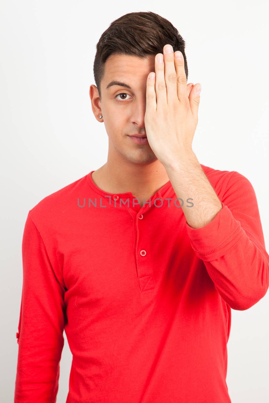 Young and handsome guy posing over white background