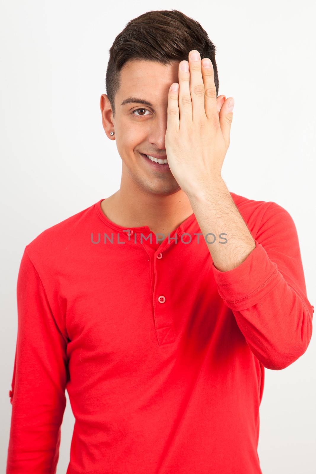 Young and handsome guy posing over white background