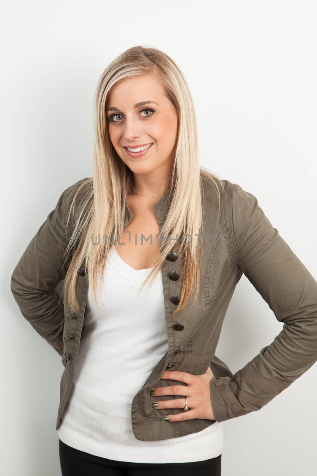 Young blond woman smiling against a white background