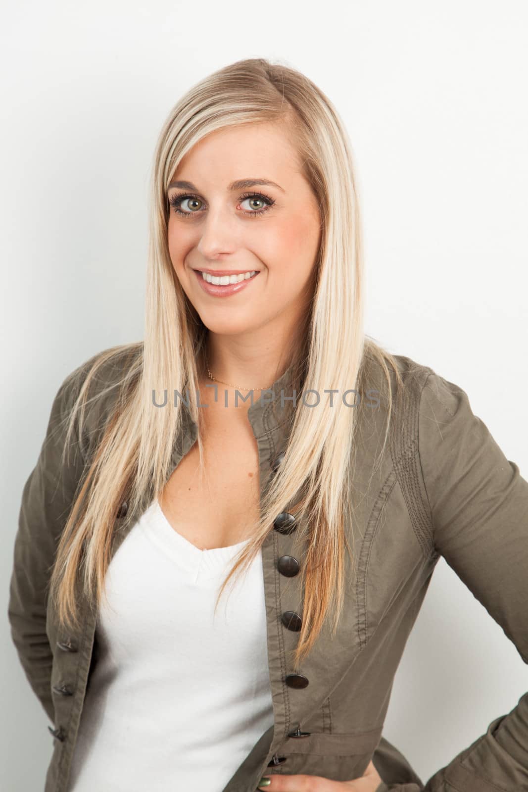 Young blond woman smiling against a white background