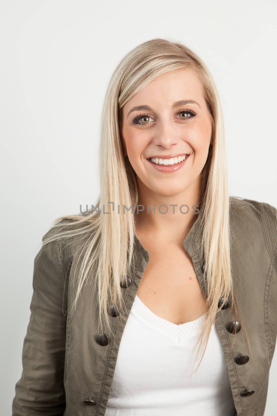 Portrait of a young blond woman smiling by Izaphoto