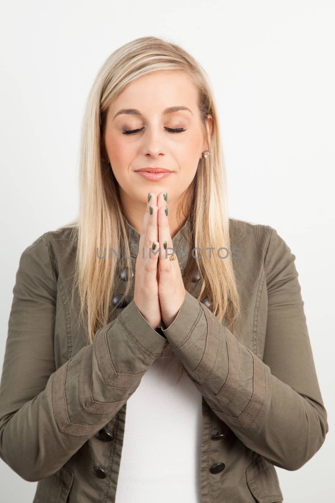 Young blond woman smiling against a white background