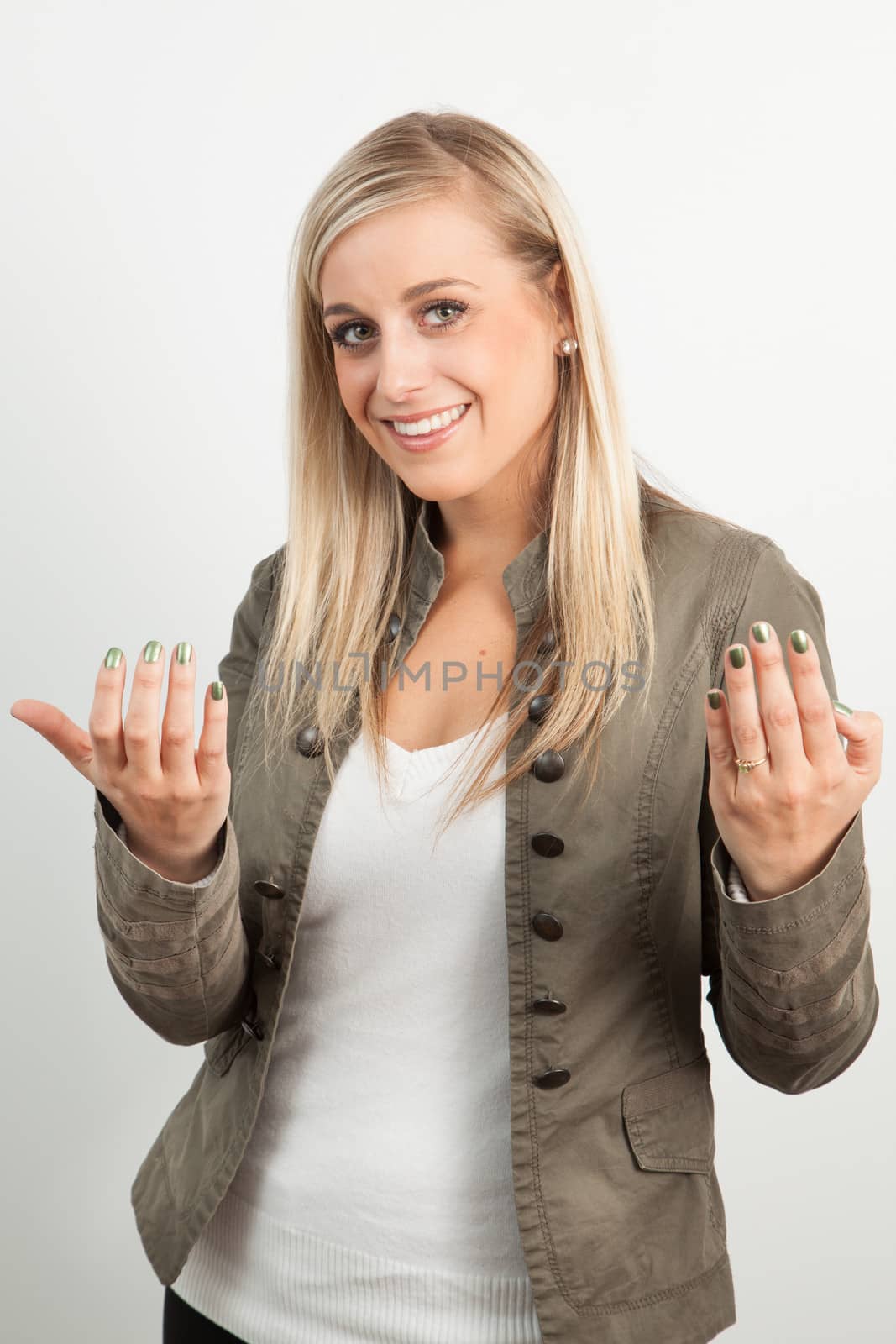 Young blond woman smiling against a white background