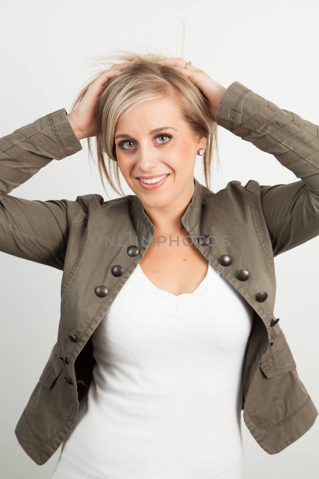 Young blond woman smiling against a white background