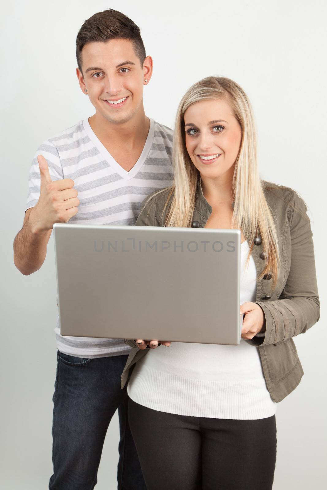 Students using a laptop against a white background