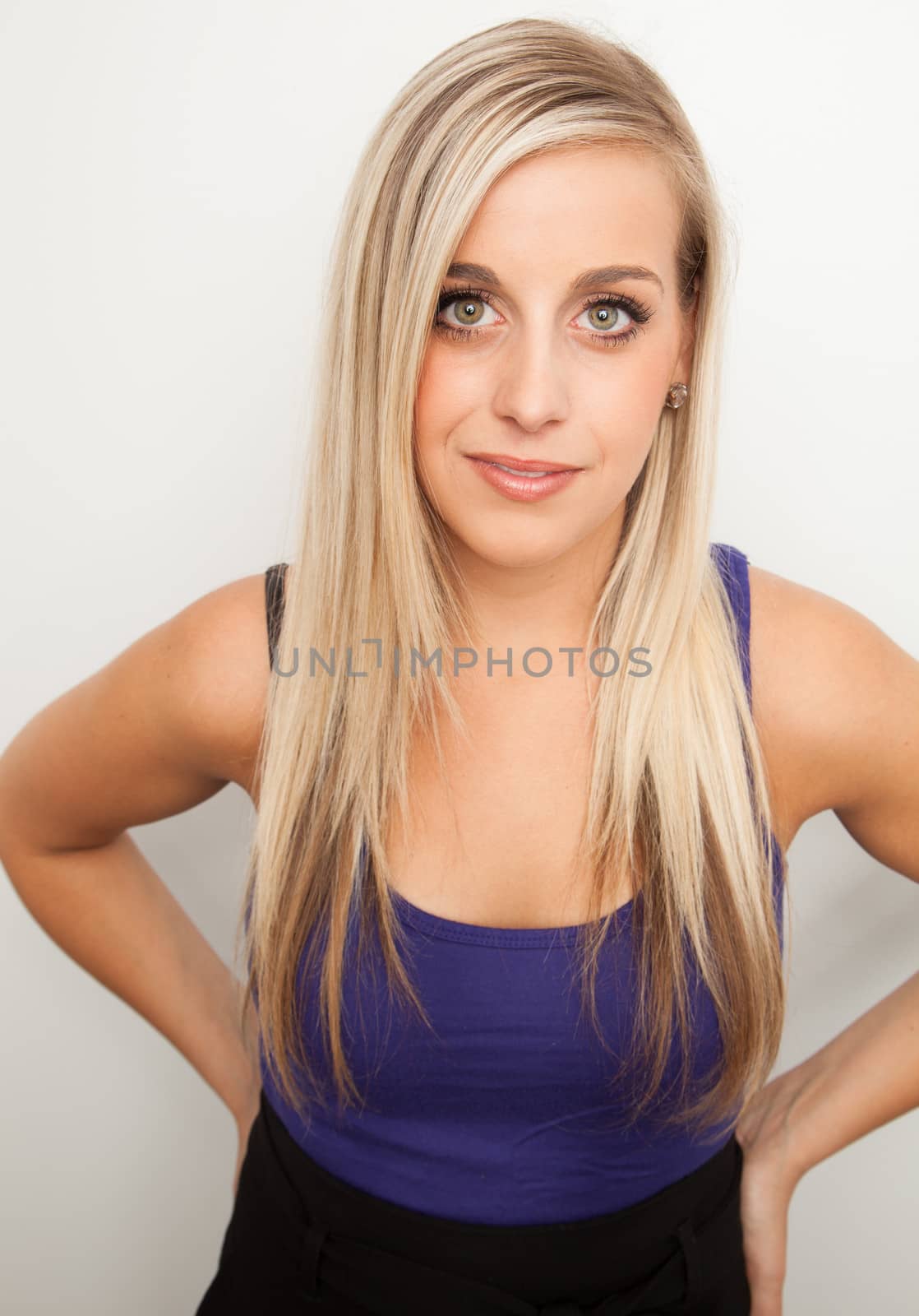 Portrait of a young blond woman smiling by Izaphoto