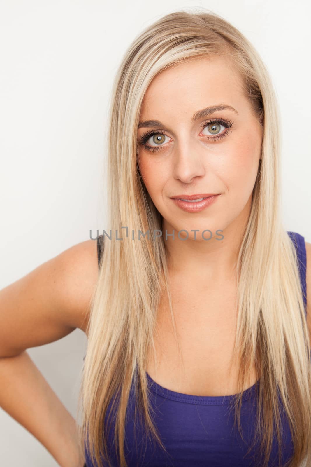 Portrait of a young blond woman smiling by Izaphoto