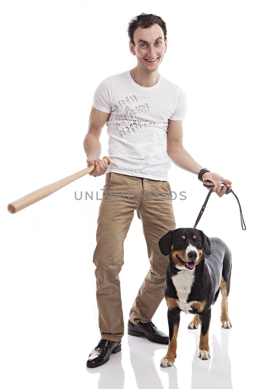 Young Caucasian man holding bat, with Entlebucher Sennenhund dog