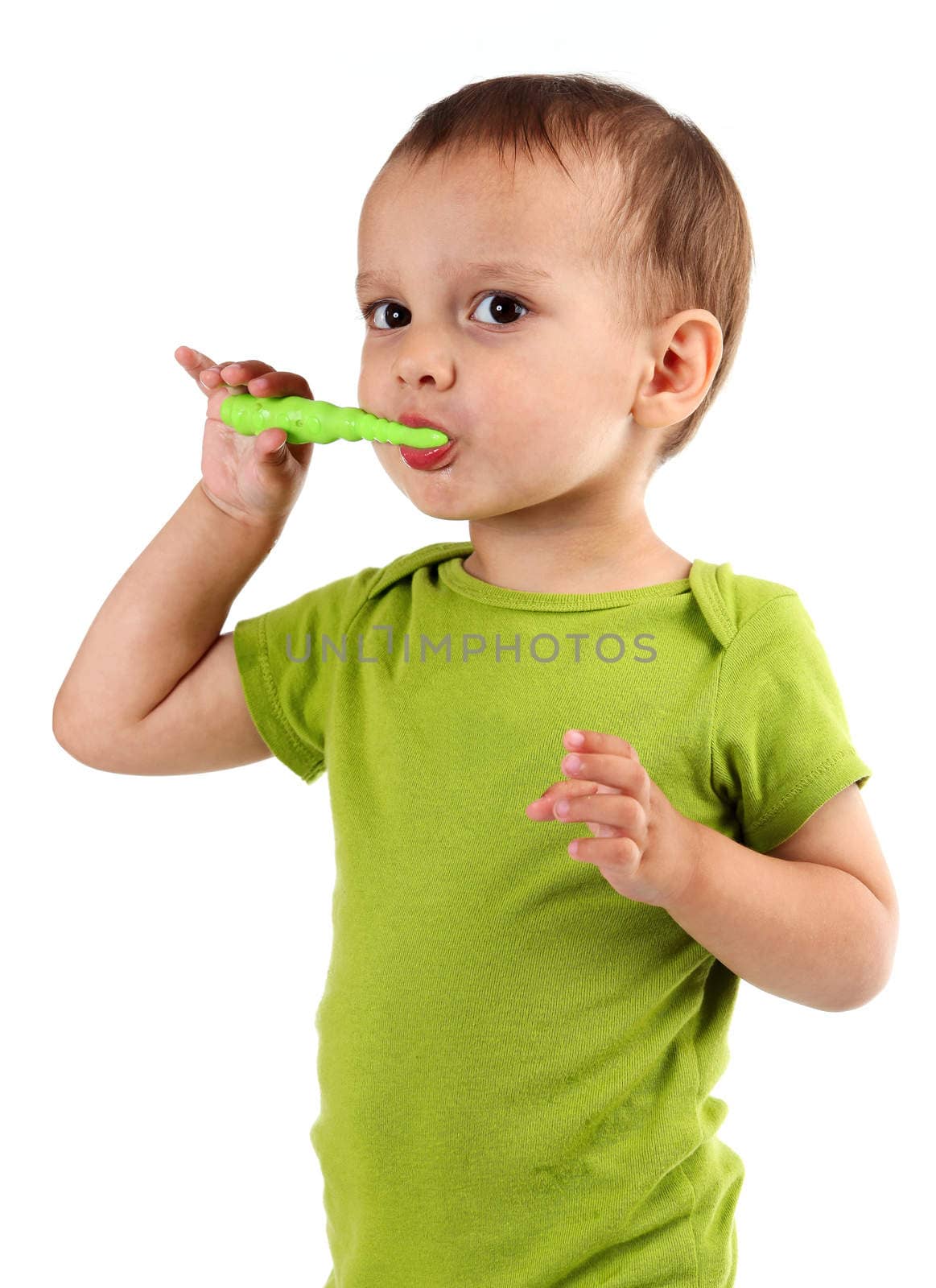 Cute little boy brushing teeth, isolated on white by photobac