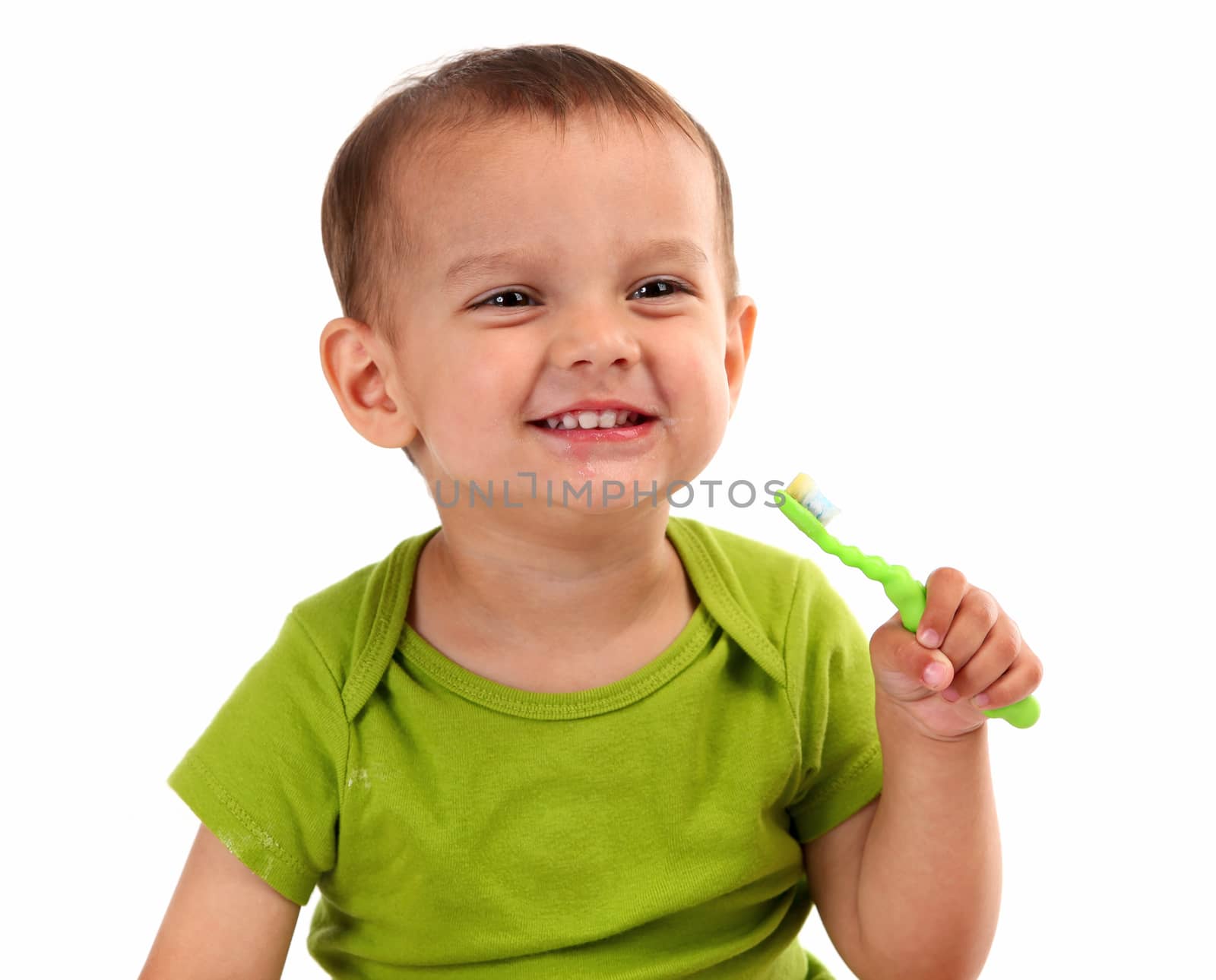 Cute little boy brushing teeth, isolated on white background