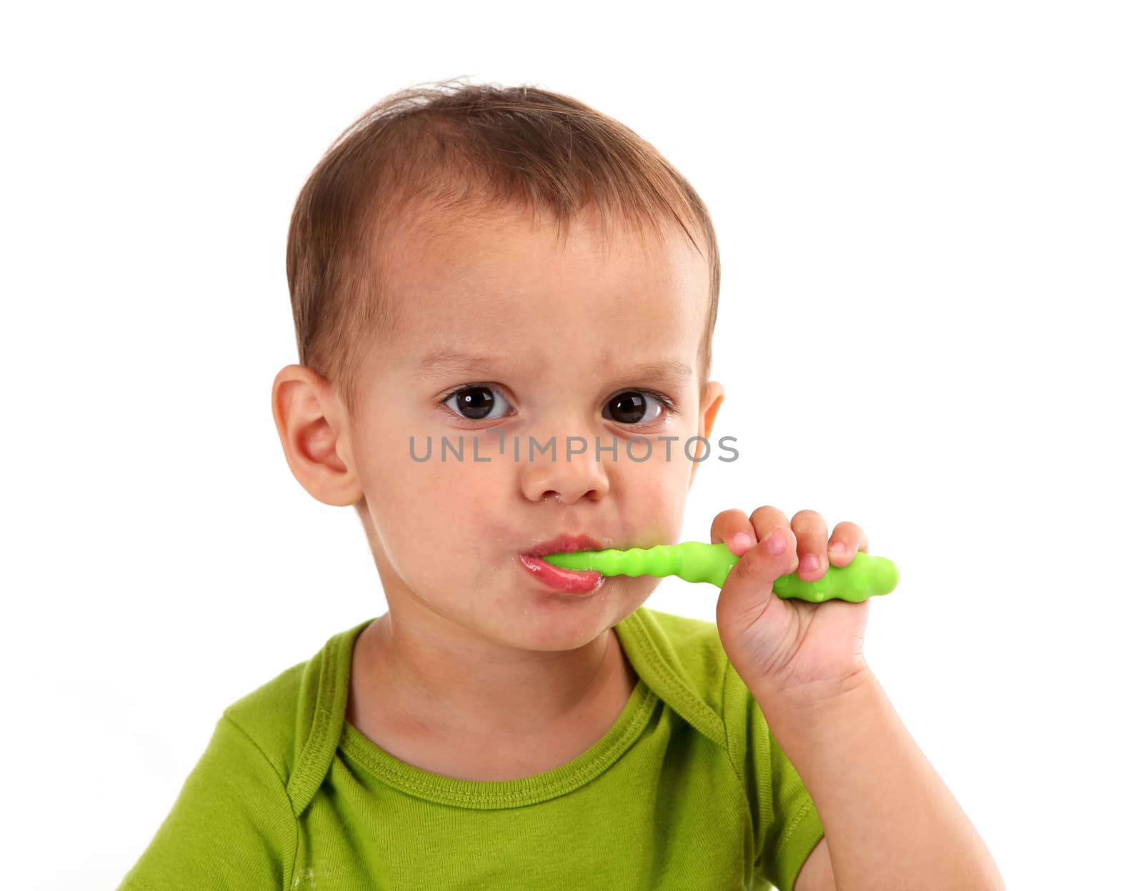 Cute little boy brushing teeth, isolated on white background