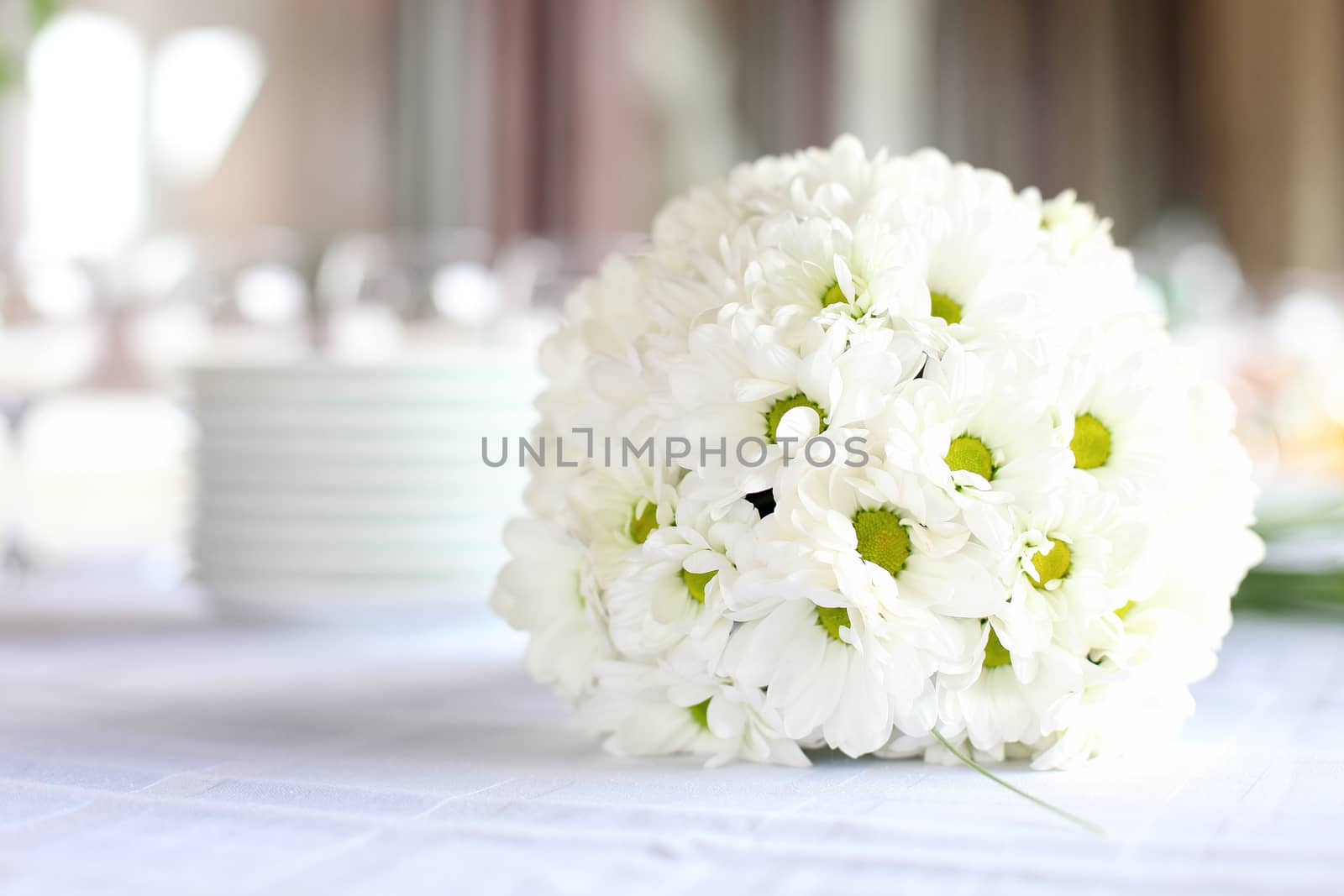 Decoration of the dining table for wedding reception, bouquet of daisies