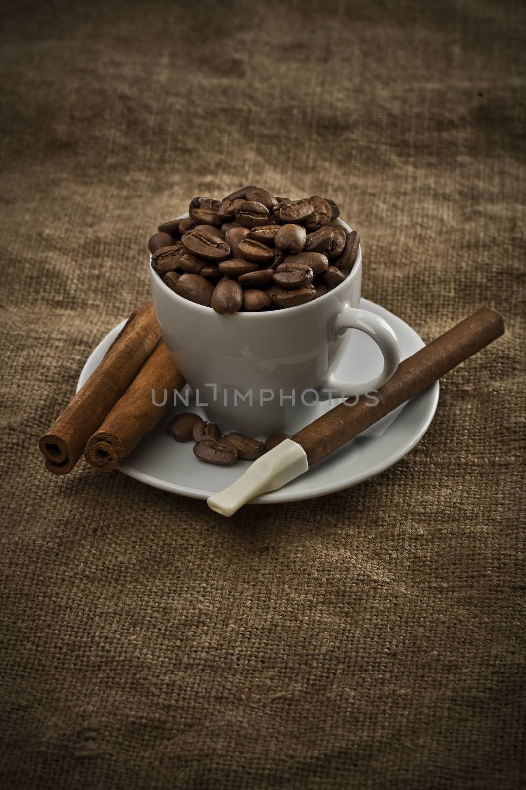 cup with beans cigar and cinnamon