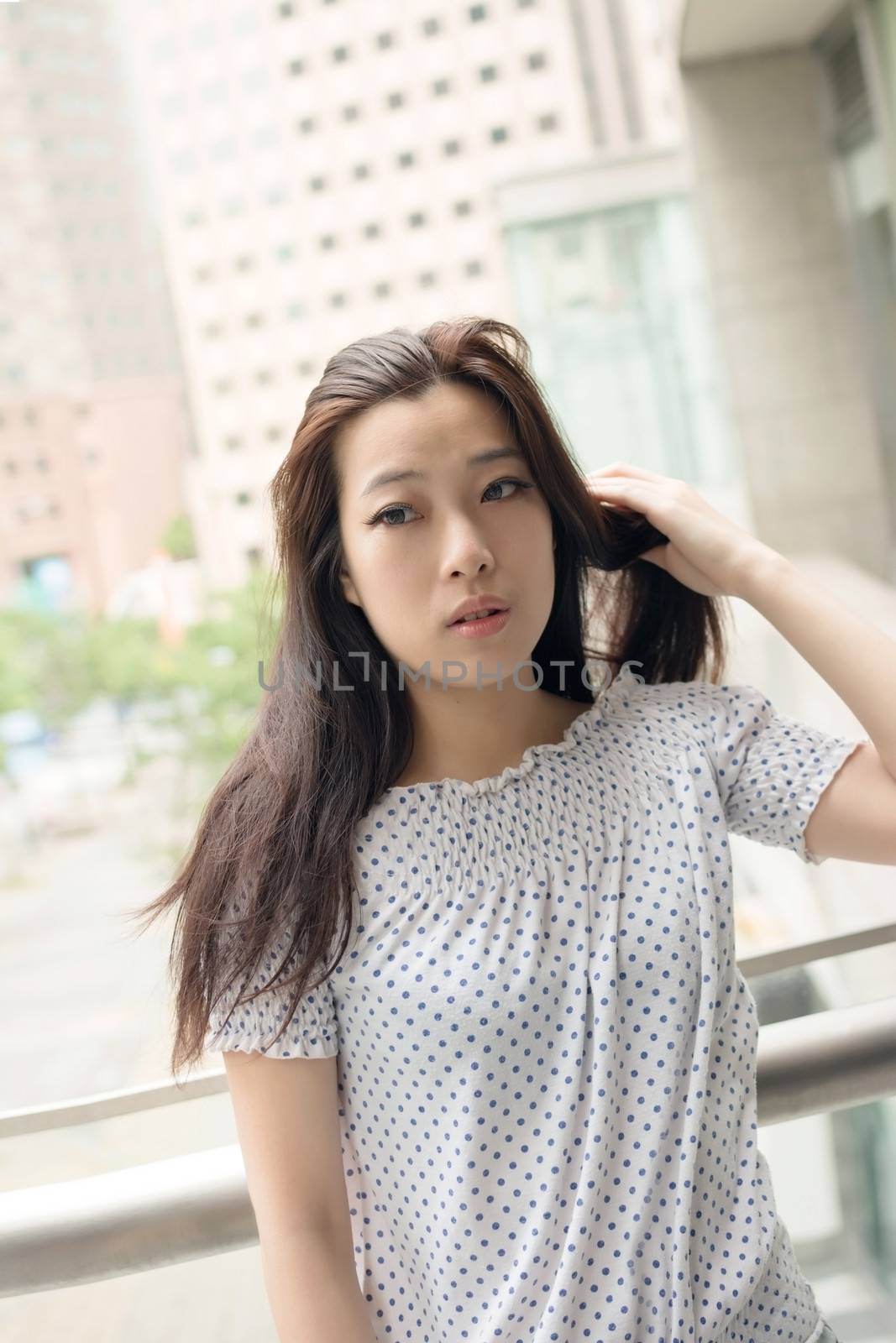Attractive young woman, closeup glamour portrait at street in modern city, Taipei, Taiwan, Asia.