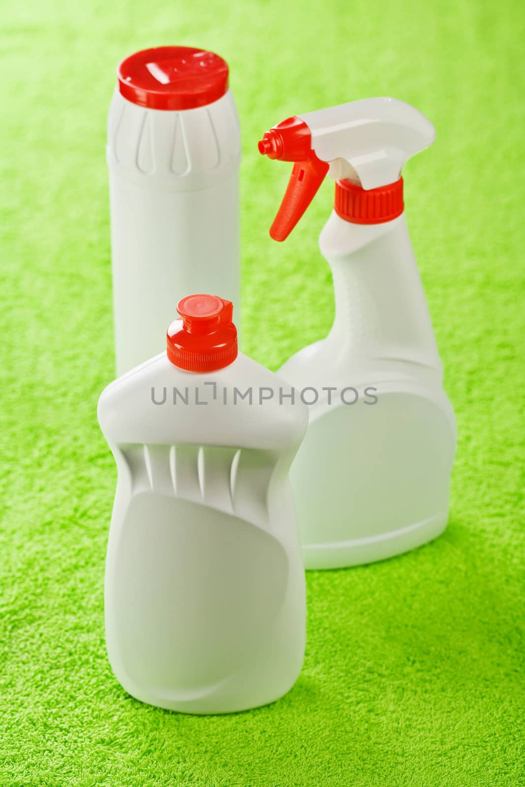 three bottles on green background