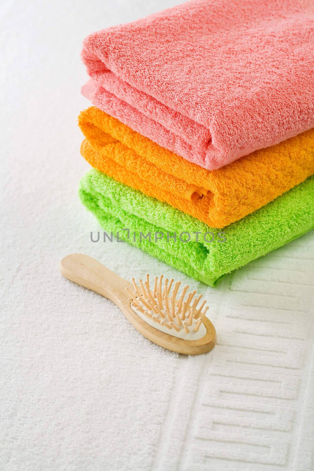 three cotton towels with hairbrush