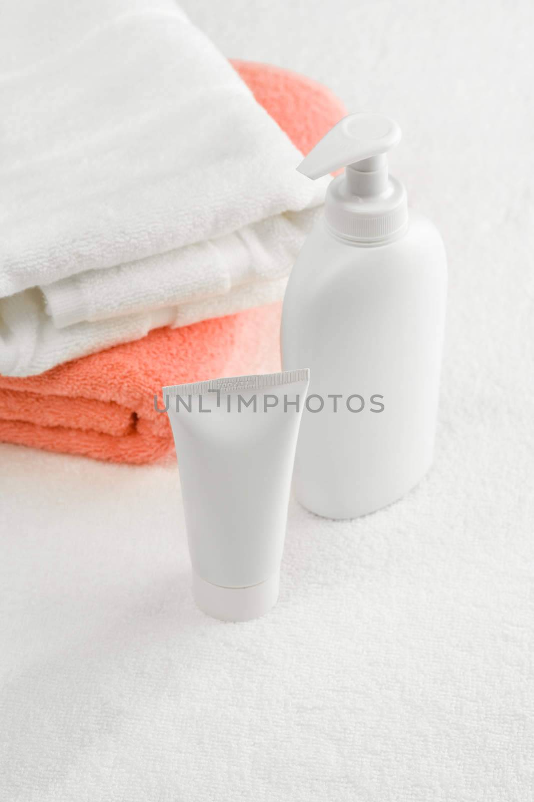 tube and spray bottle with towels