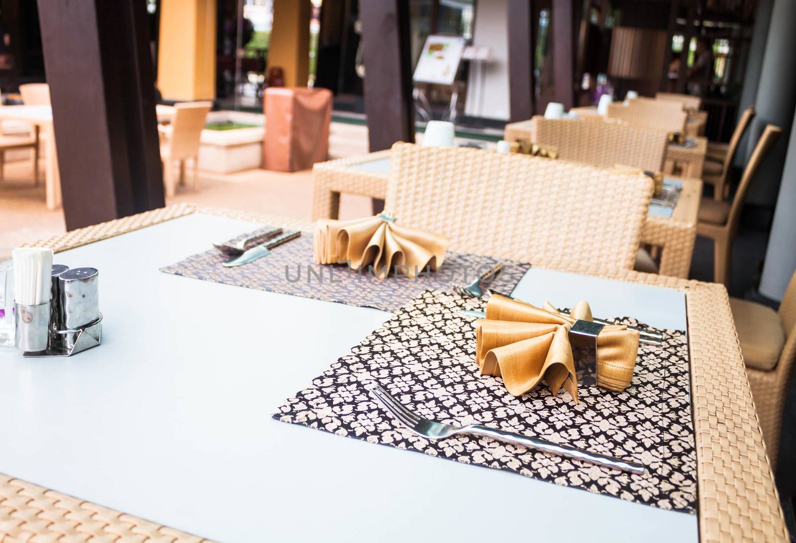 Opened air dining room with oriental style table  by punsayaporn