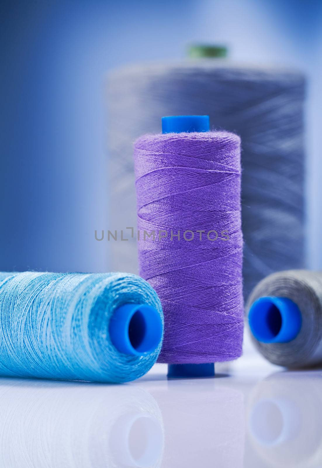 sewing spools on  blue background