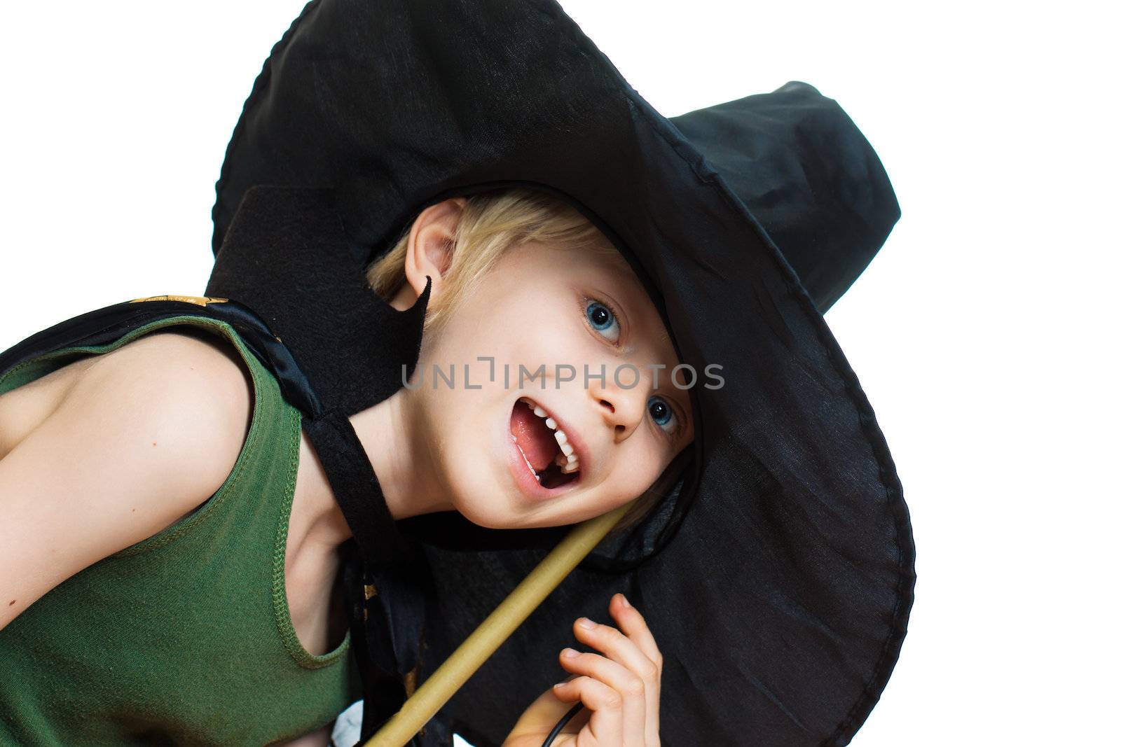 A cute boy dressed up as a witch. Isolated on white.