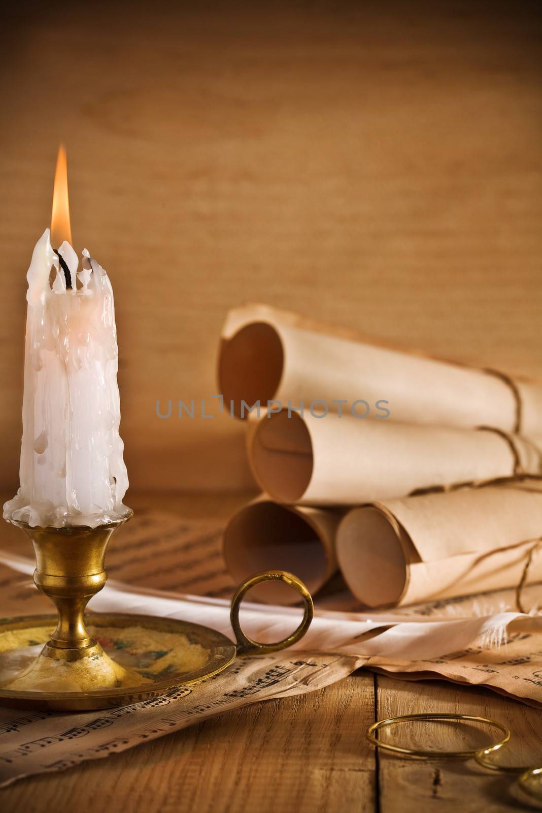 candle and old roll of paper
