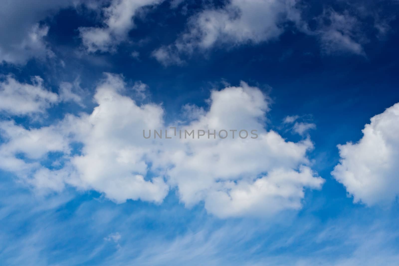 cumulus and cirrus clouds on a blue sky