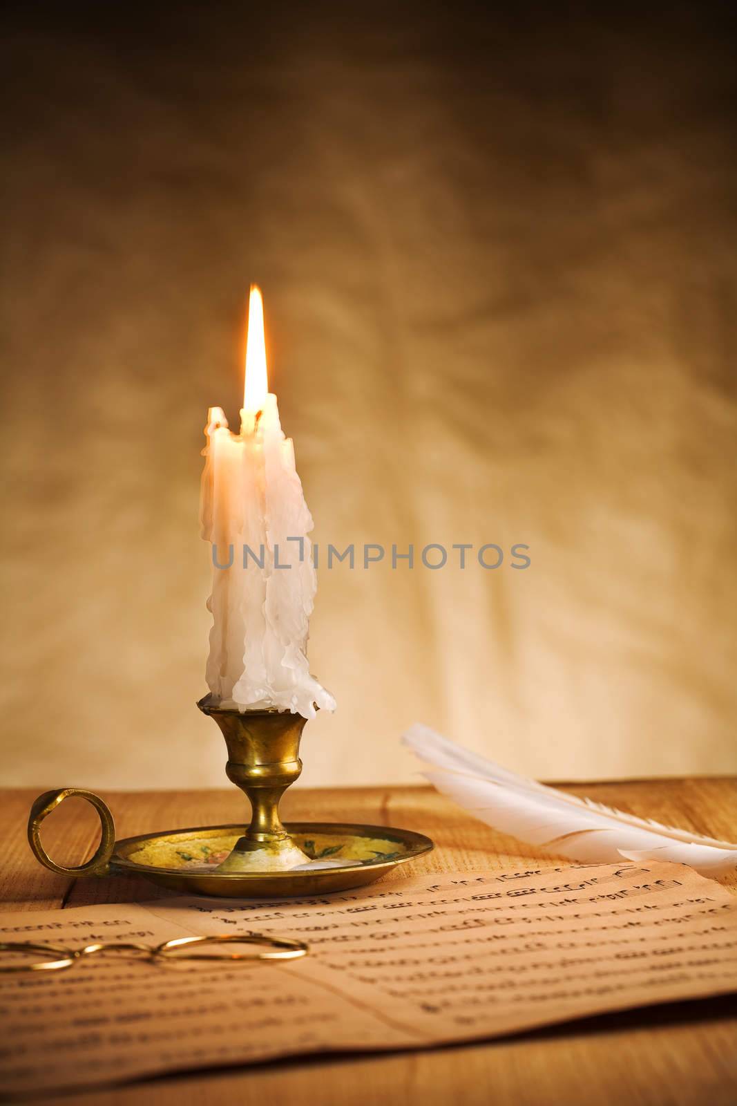 burning candle and music sheet