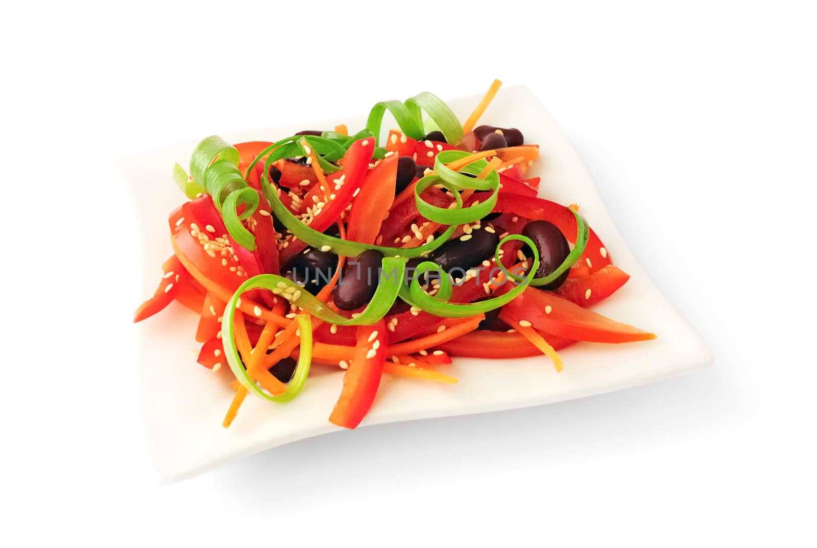 A salad of tomatoes, sweet peppers, red beans, carrots with sesame