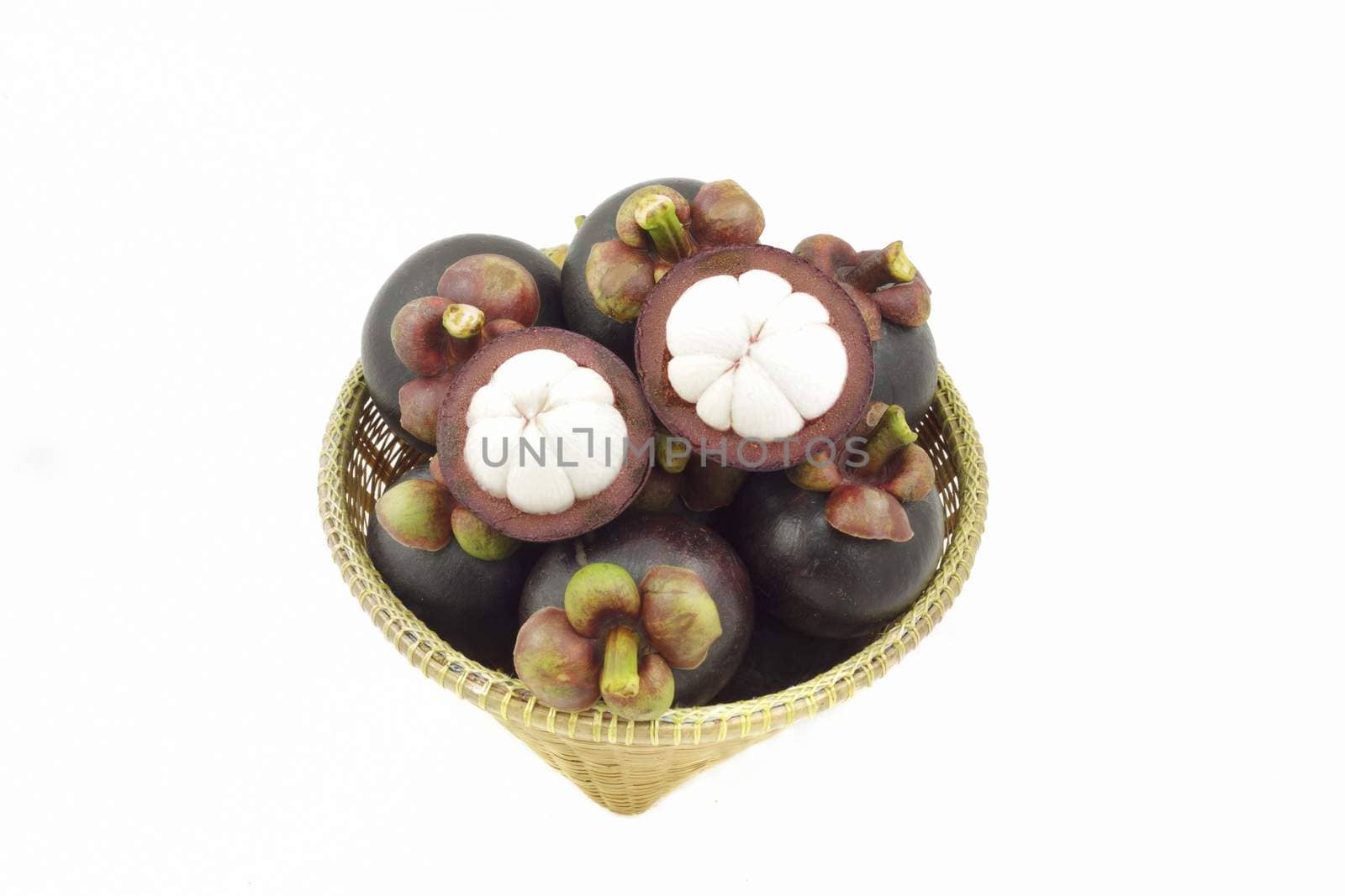 Mangosteen Thai fruit in wicker basket isolated on white background.