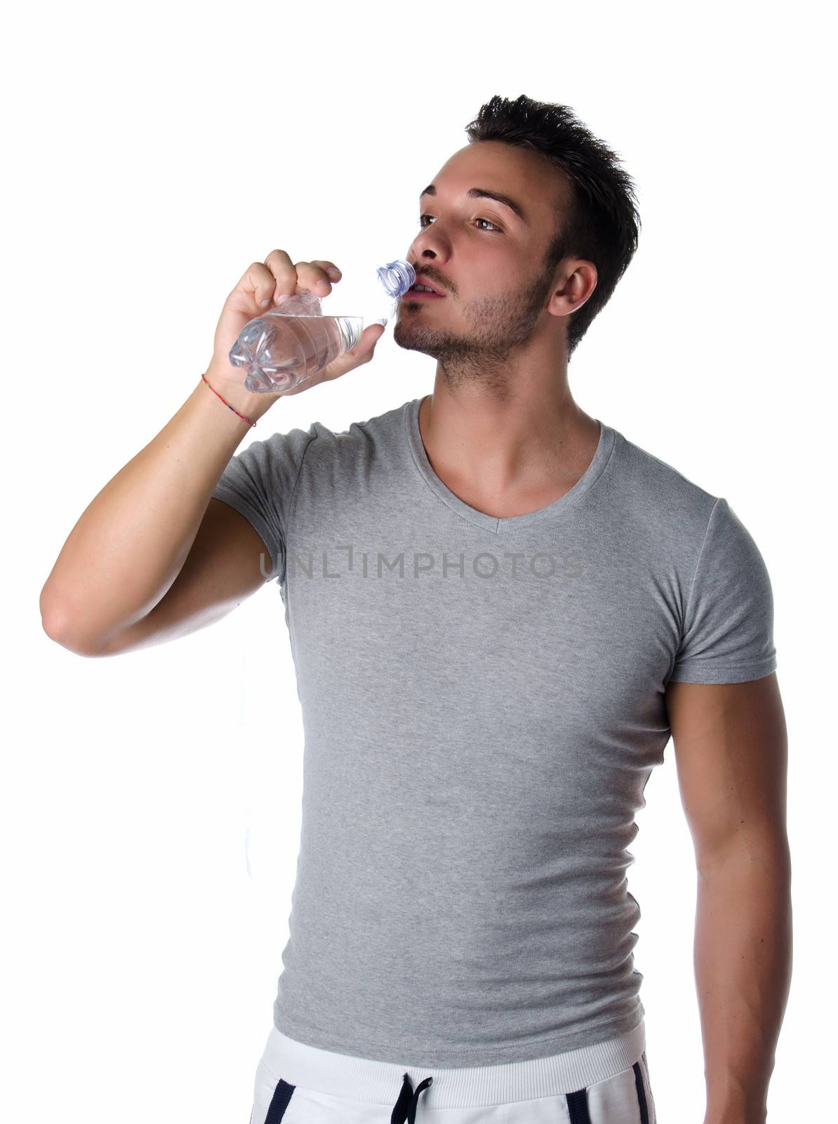 Handsome and athletic young man drinking water by artofphoto