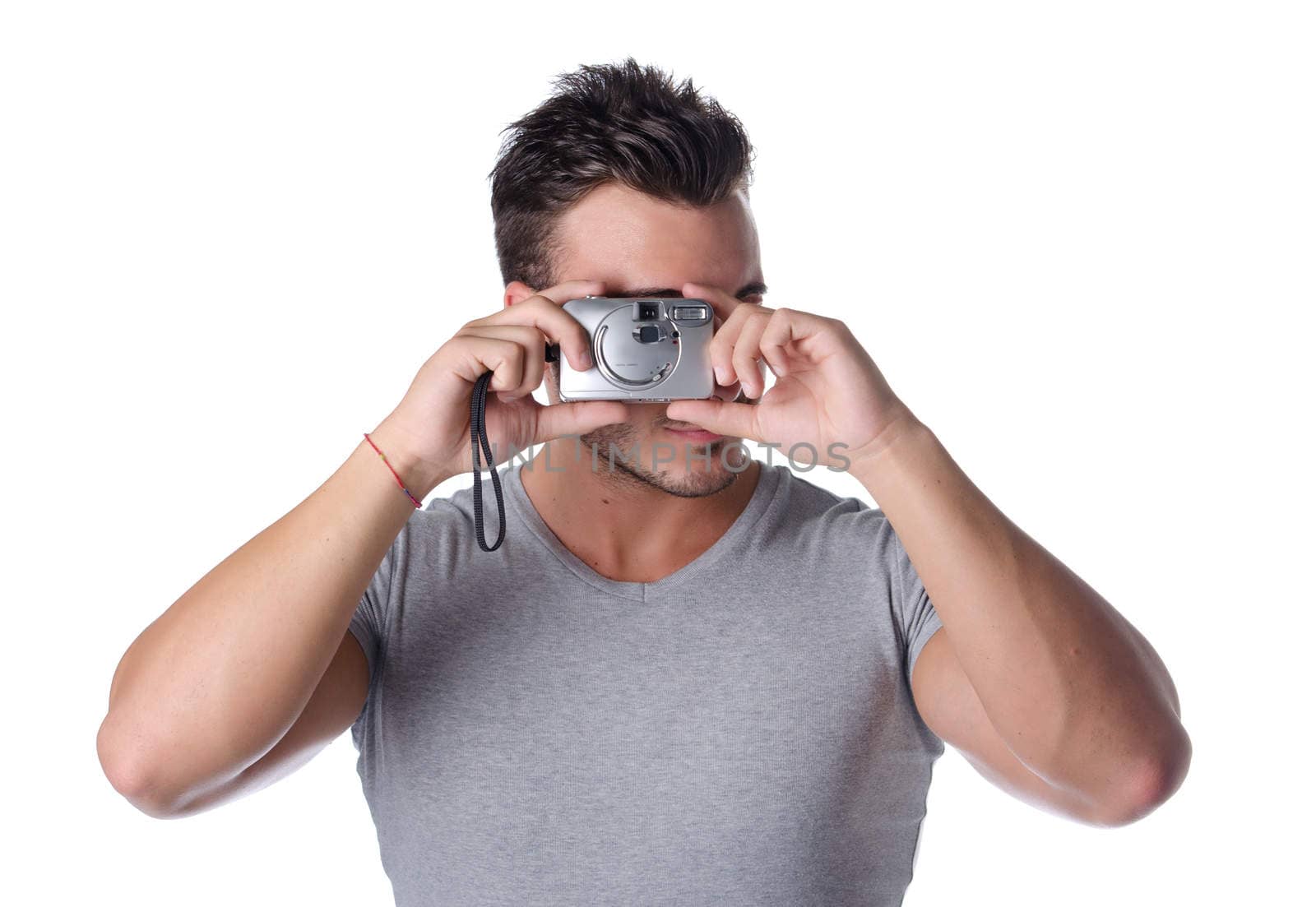 Handsome young man taking photo with compact camera by artofphoto