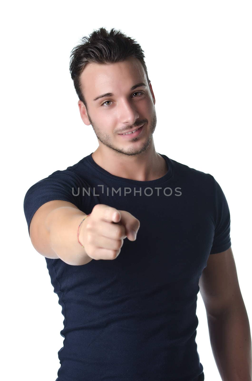 Smiling young man gesturing with his hand, pointing finger at you, isolated on white