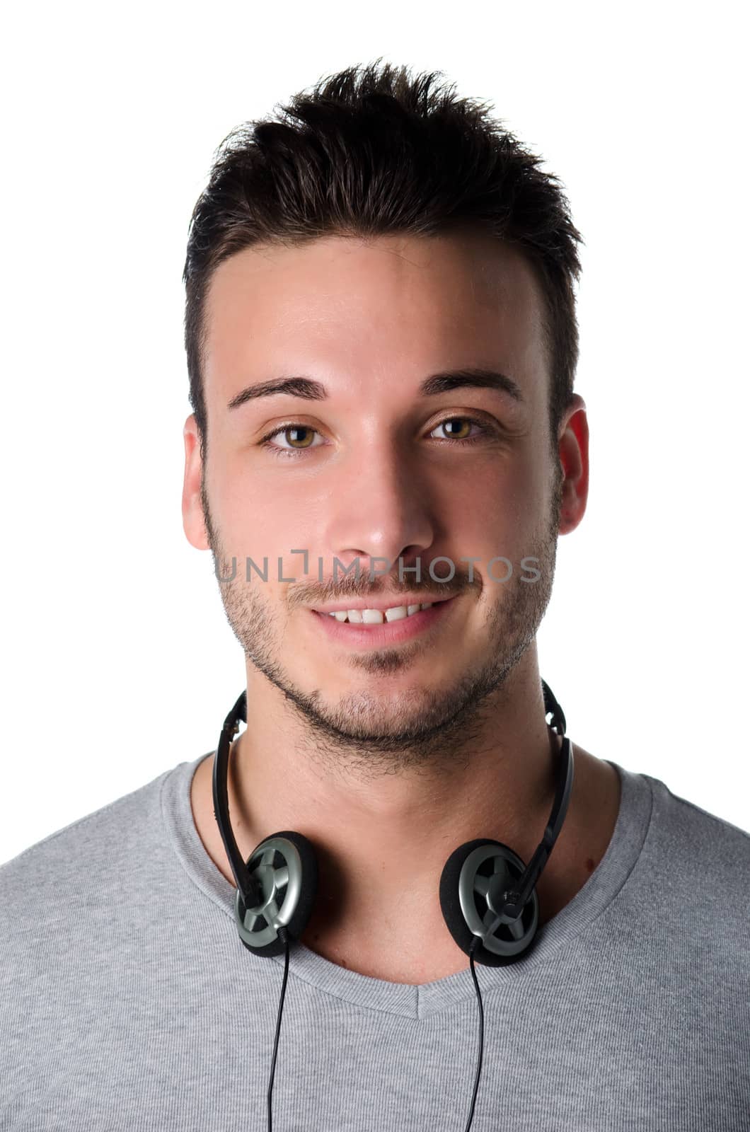 Attractive smiling young man with headphones around his neck by artofphoto