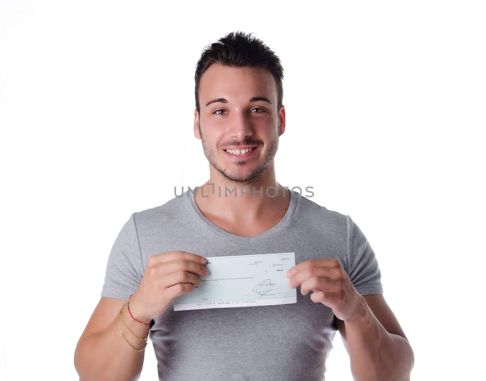 Happy, smiling young man with check (cheque) in hands, looking at camera