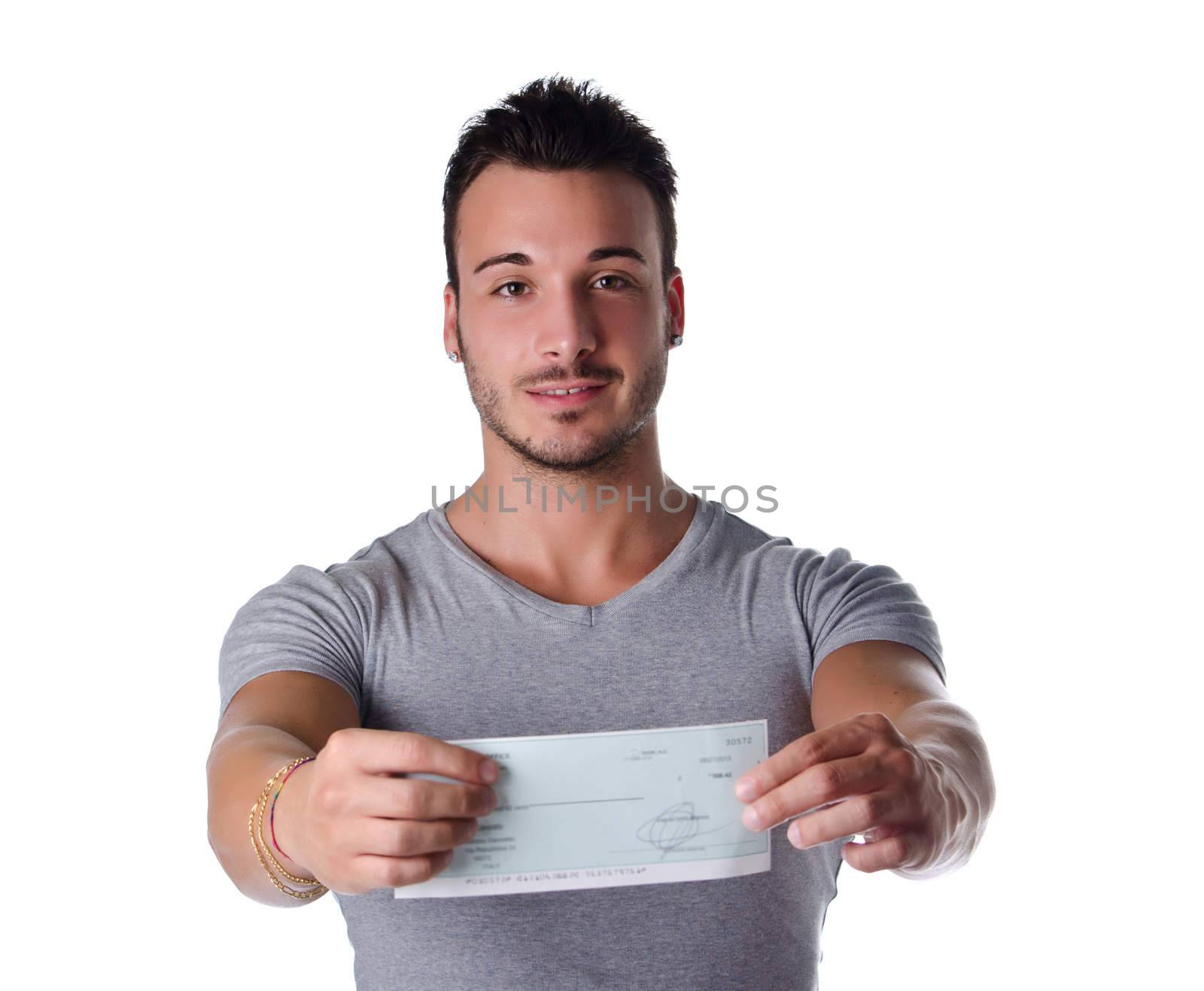 Young man showing check (cheque) in his hands, looking at camera