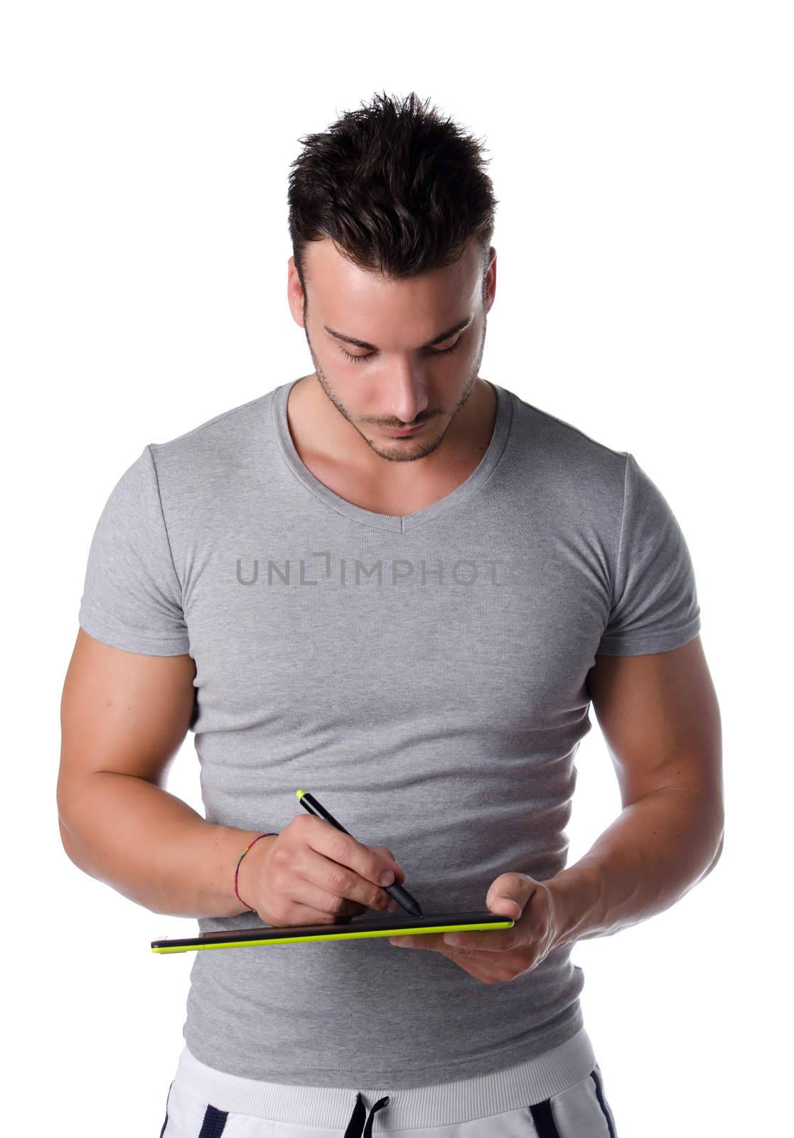 Handsome young man sketching on digital graphic tablet by artofphoto