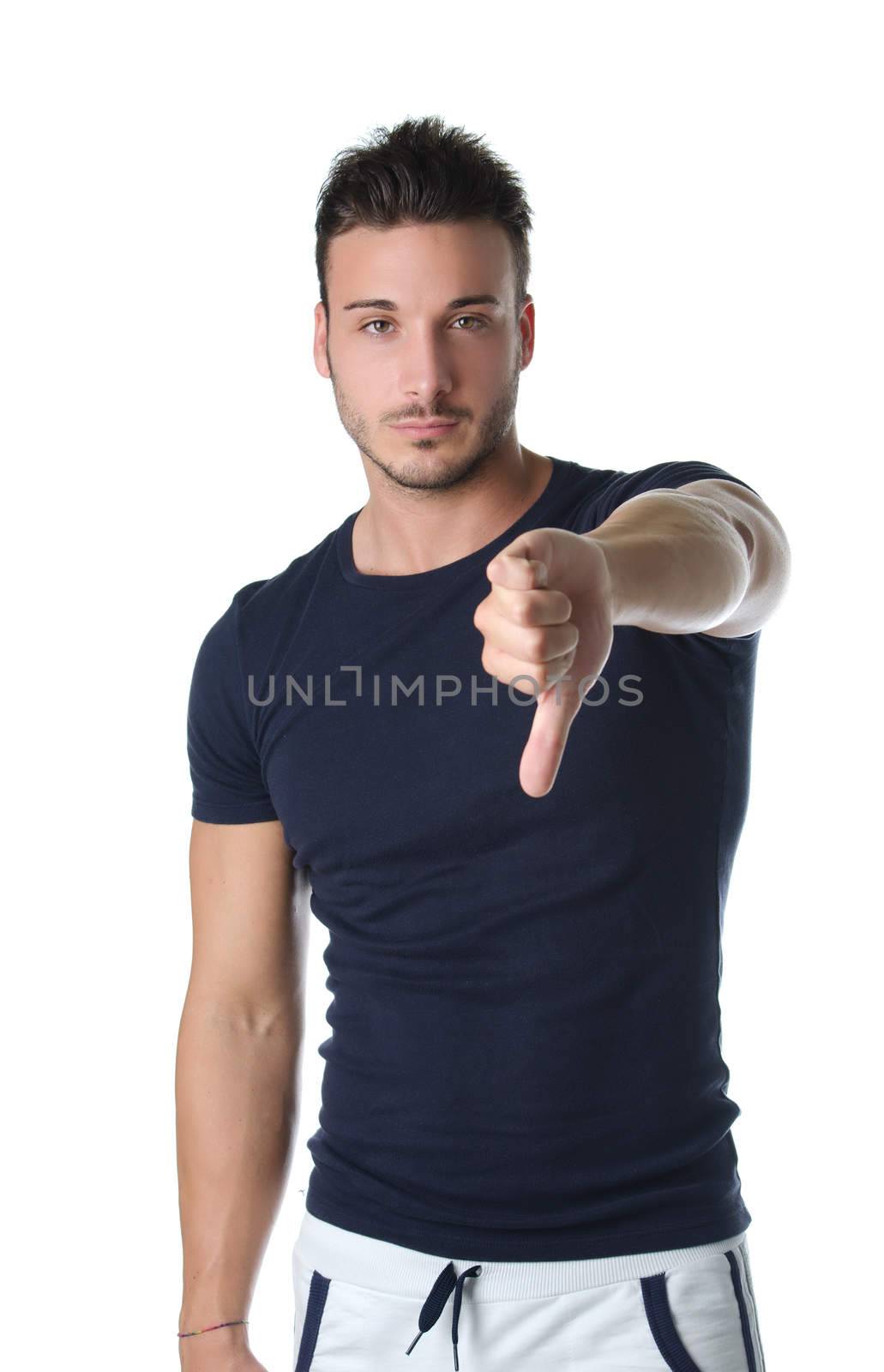 Young man doing thumb down sign by artofphoto
