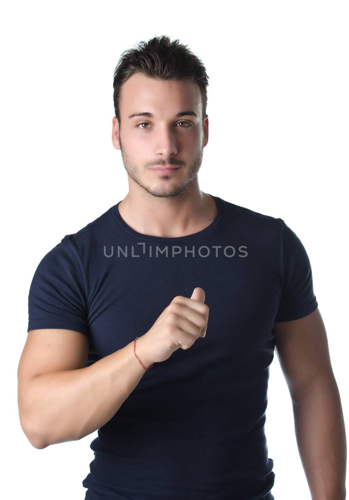 Attractive and athletic young man pointing thumb finger at himself, confident expression