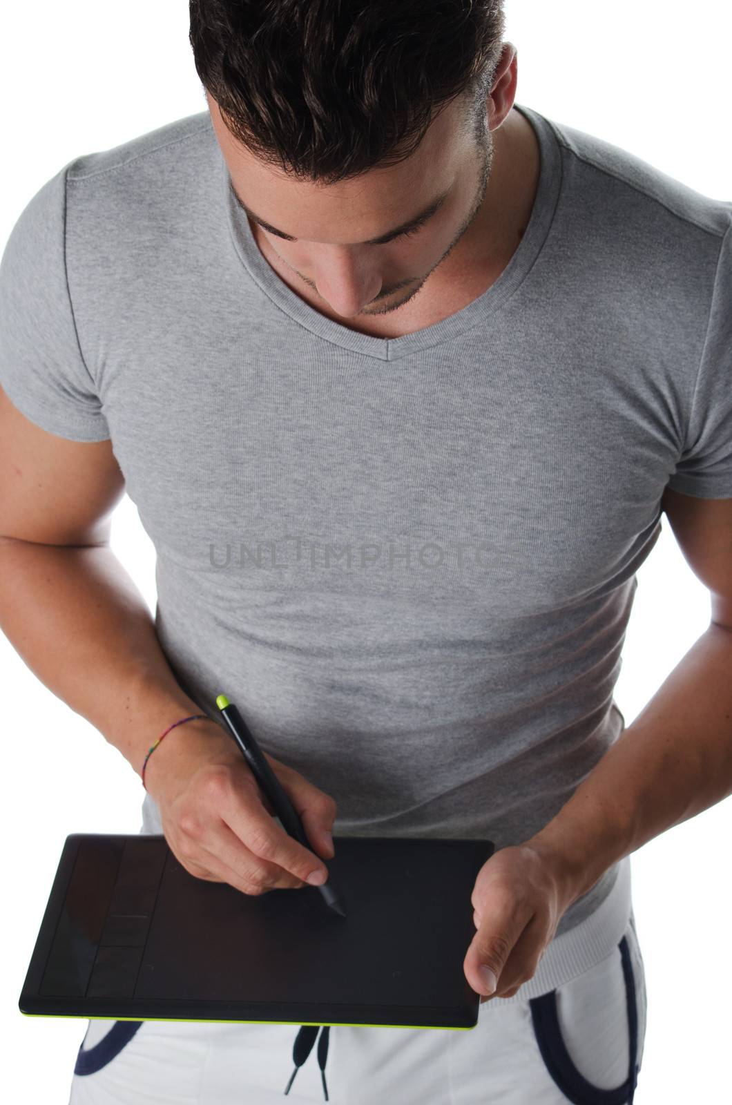 Athletic young man using digital graphic tablet to draw sketch